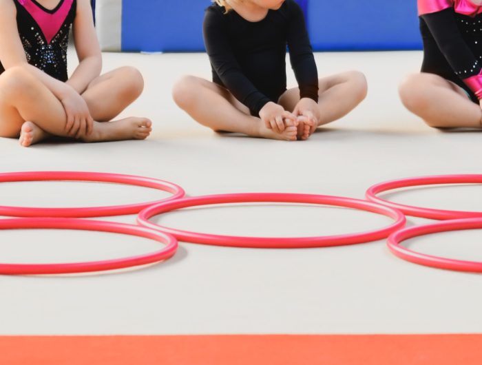 children-sitting-cross-legged-with-hula-hoops-2026-01-06-09-28-16-utc