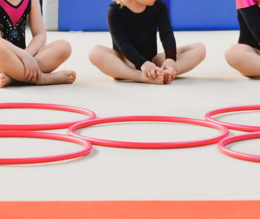 children-sitting-cross-legged-with-hula-hoops-2026-01-06-09-28-16-utc