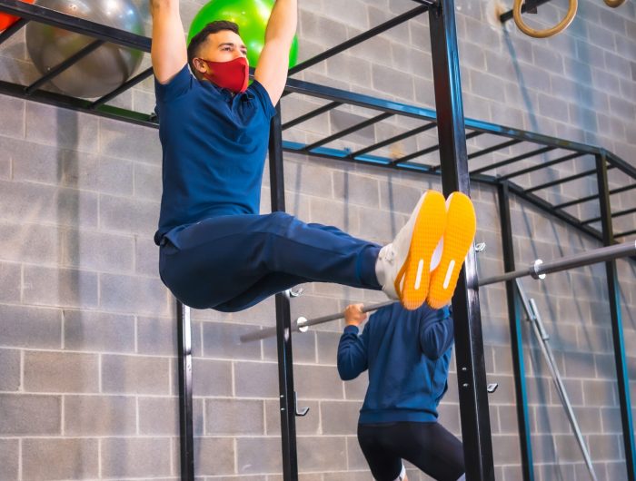 A view of Two athletes performing strength exercises in the gym during the coronavirus pandemic